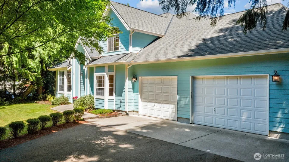 Front of a turquoise two-story house with a double garage, shown small and in grey as a portal thumbnail.